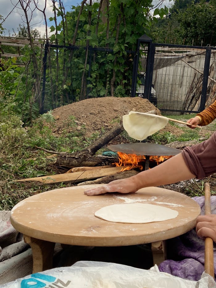 services-02 Outdoor bread making on open fire with traditional methods and tools.